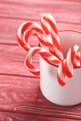 Christmas candy can on a red wooden table