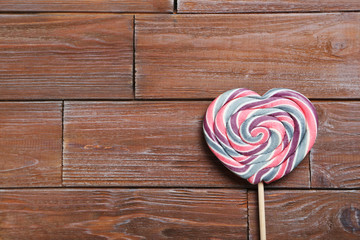 Sweet lollipop on a brown wooden table