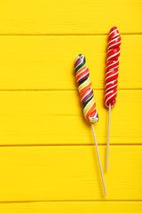 Sweet candies on yellow wooden table