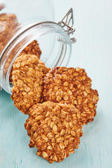Homemade oatmeal banana cookies out of a jar on blu wooden table - Text space on the right