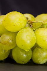 Bunch of grapes on a black slate stone