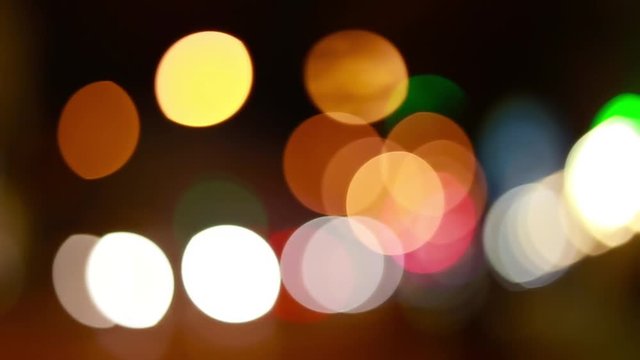 Christmas street illumination. Defocused city lights. Blurred night traffic lights