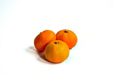 Three tangerines on a white background