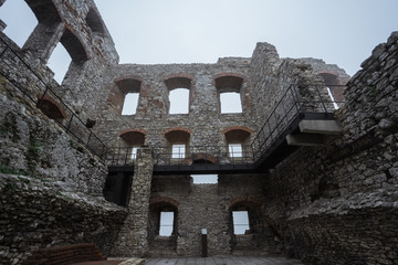 windows and room remain of medieval castle ruin in bad weather