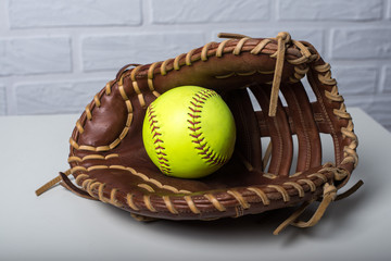 Closeup of a Softball Glove and ball isolated on white background