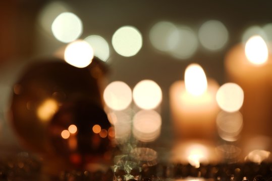 Defocused Christmas decoration:  balls against candlelight background