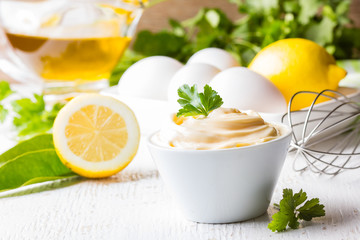 Homemade sauce Mayonnaise and ingredients on white background