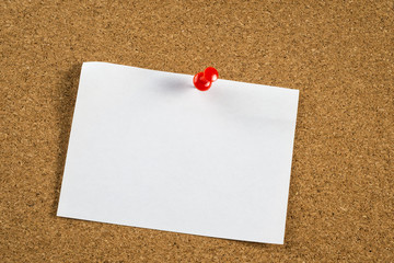 Thumbtack and note on corkboard