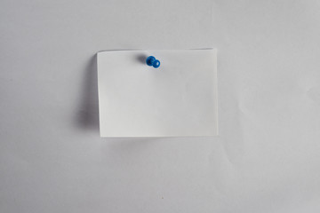 Thumbtack and note on corkboard