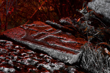 Abandoned cemetery, old tomb with a cross at night