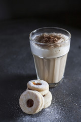  latte in a transparent glass with cakes