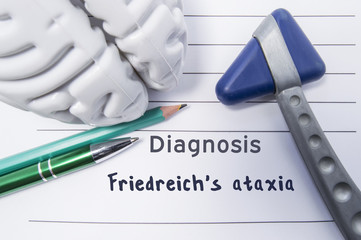 Neurological diagnosis of Friedreich's ataxia. Neurological hammer, shape of brain, pen and pencil the lying on medical report, labeled with diagnosis of Friedreich's ataxia. Concept for neurology