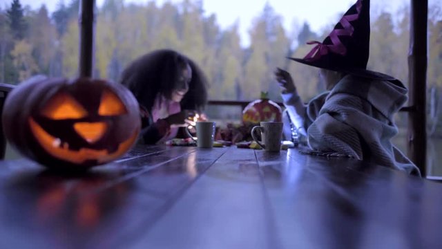 Two teen girls sharing candys after trick or treat on Halloween