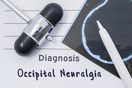 Diagnosis Occipital Neuralgia. Written medical report, which indicated neurological diagnosis Occipital Neuralgia, surrounded by MRI of brain and reflex hammer on desk in doctor office 