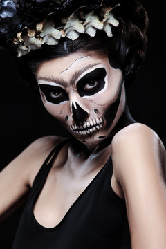 Woman in Halloween costume of Frida Kahlo. Skeleton or skull makeup.