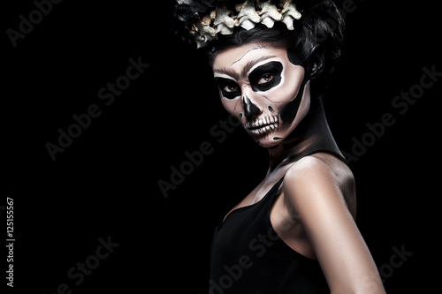 Woman in Halloween costume of Frida Kahlo with copy space. Skeleton or skull makeup.