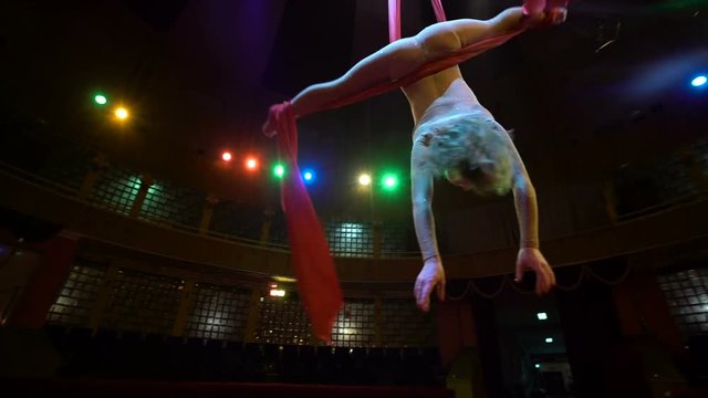 woman dancer on aerial silk, aerial contortion, Slow motion