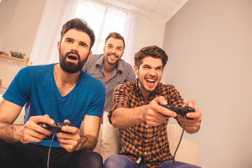 Three best happy friends playing video game