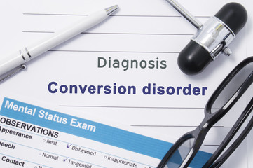 Diagnosis Conversion disorder. Medical note surrounded by neurologic hammer, mental status exam with name in large letters psychiatric diagnosis of Conversion disorder. Concept photo for psychiatry