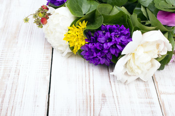 bouquet of colorful flowers on white wooden planks