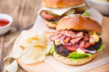 Burgrers with bacon on wooden board