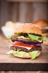Double burger on wooden board. Close up