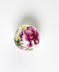 Purple isolated ceramic bead with floral design on white background 