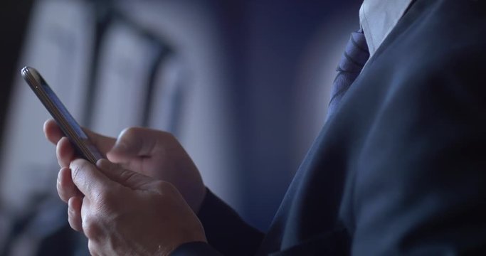 Business person traveling on air plane checking mobile cell smartphone