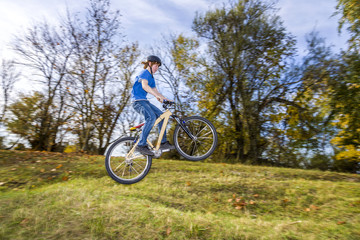 Fototapeta na wymiar boy jumps over a ramp with his dirt bike