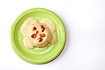 Bisquits and Gravy on a Green Plate isolated on a white backgrou