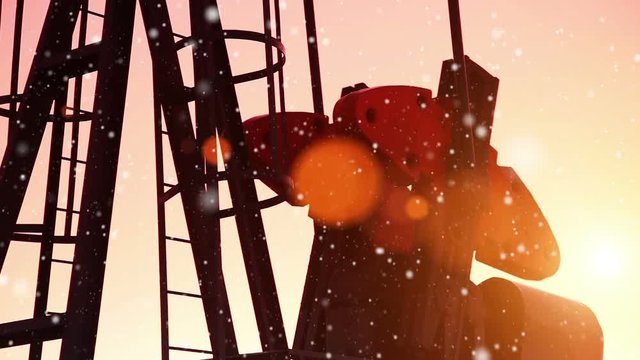 Oil field pumpjack silhouette with setting sun. Lens Flare.