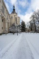 beautiful grand castle covered in snow in winter in Czech Republ