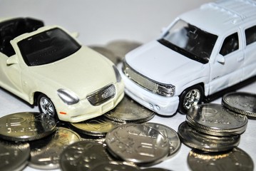 The cost of the car/Faced SUV and coupe in the background of ruble coins