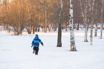 child boy on winter walk run away