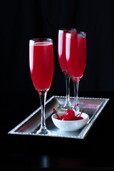 Maraschino Cherry Bellinis on a Black Background