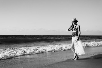 Beautifull 40 years old woman walking on the beach