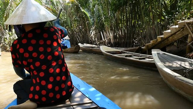 MEKONG DELTA, VIETNAM - 2015: Vietnamese boat lady southern Vietnam