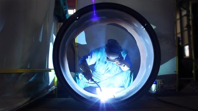 HD 1080: Welder inside Pipe, Welding the Seam to Create One Continuous Section of Pipe.