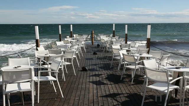 External Cafe terrace on the beach with table and chairs.Cafe is located in Greece in Platamonas.