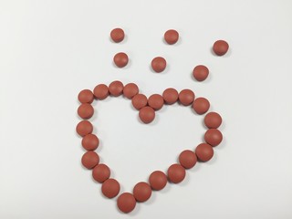 Brown medicine heart shape on white background