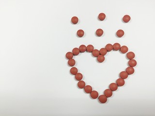 Brown medicine heart shape on white background