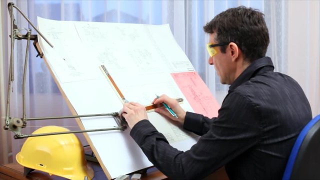 Engineer working on blueprint.