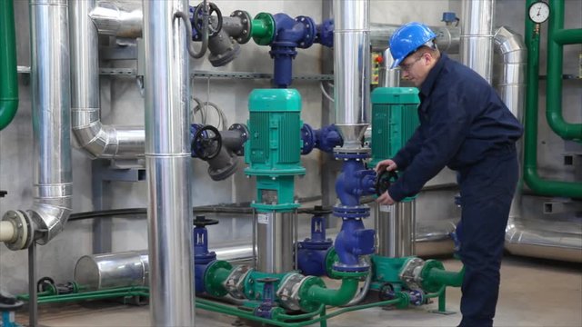HD 1080: Man working in a factory, controls the operation of devices in a Heating Plant