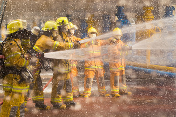 Firefighters training, foreground is drop of water springer, Selective focus