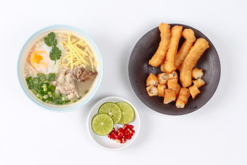 Rice porridge with mined pork and chicken lever served with side dish as Patongko (deep-fried dough stick) and spicy sour filling.