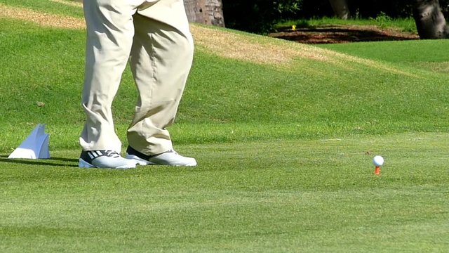 Perfect golf resort in Dubai city.Man plays golf,male legs only.Slow motion, high speed camera