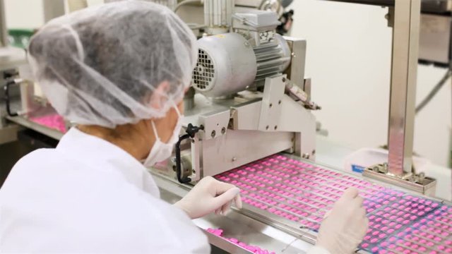 HD 1080: Woman working at the pharmaceutical factory, two different video shots. Shallow DOF.