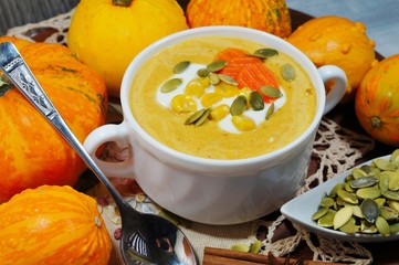 spicy pumpkin soup in a white bowl, selective focus
