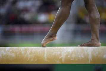 Female gymnast on balance beam during competition
