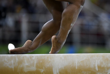 Female gymnast on balance beam during competition
